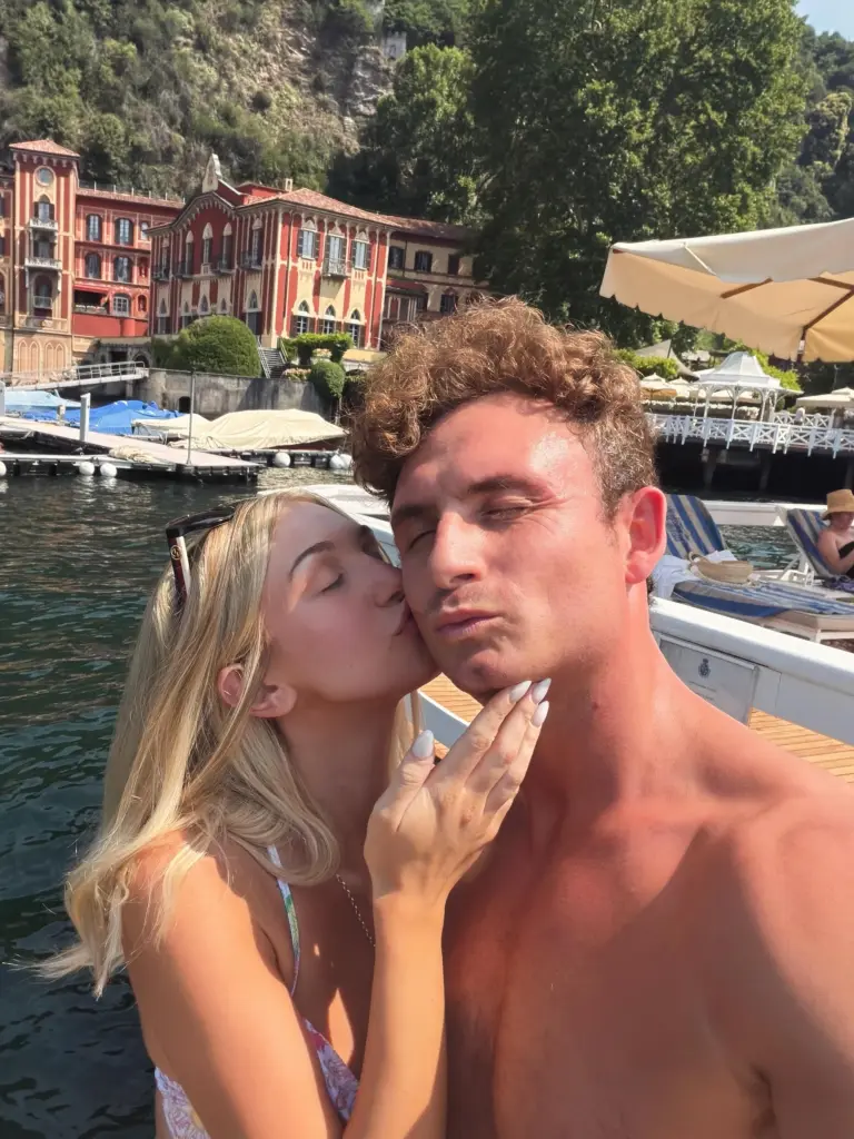 Jordan Meyers kissing James Kennedy's cheek on a boat.