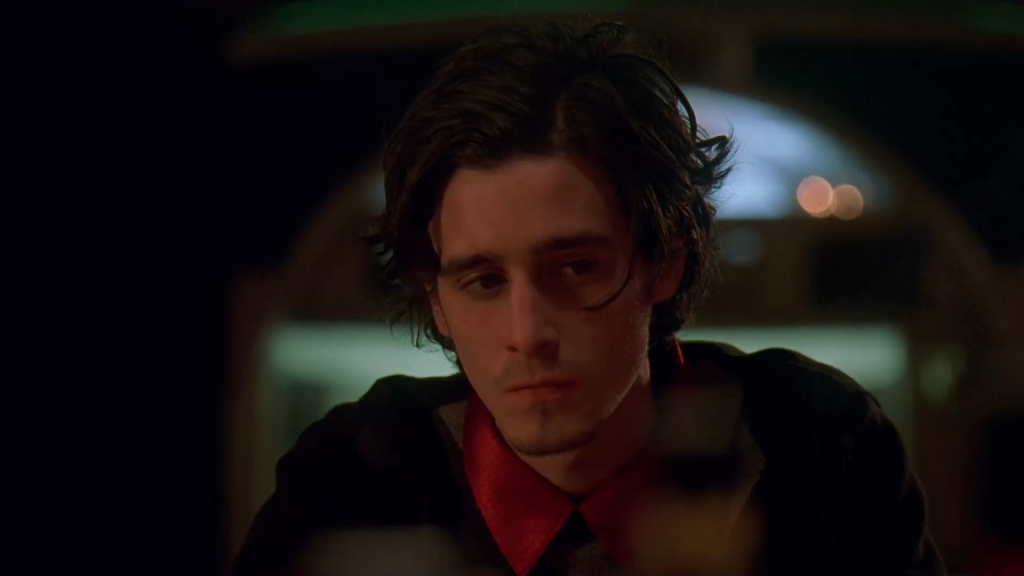James Ransone in The Wire, looking down with a serious expression.