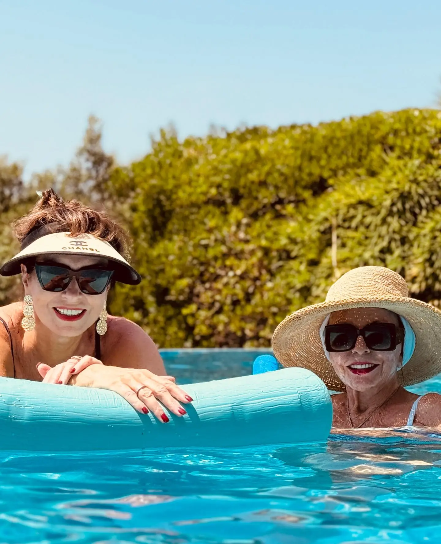 Joan Collins and Alison Papworth in a swimming pool.