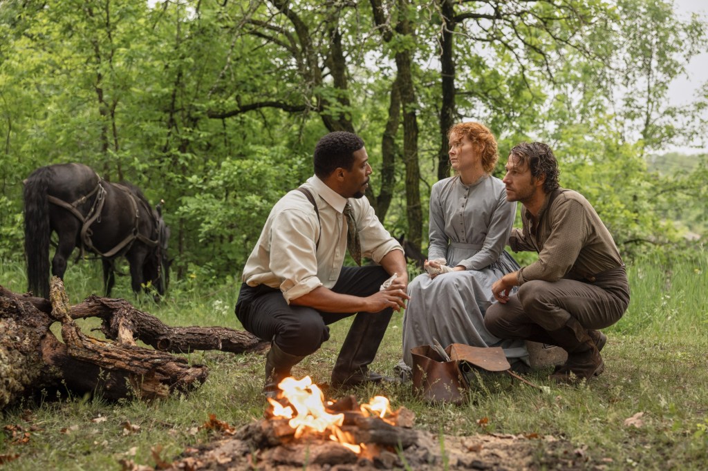 Jocko Sims, Crosby Fitzgerald, and Luke Bracey around a campfire.