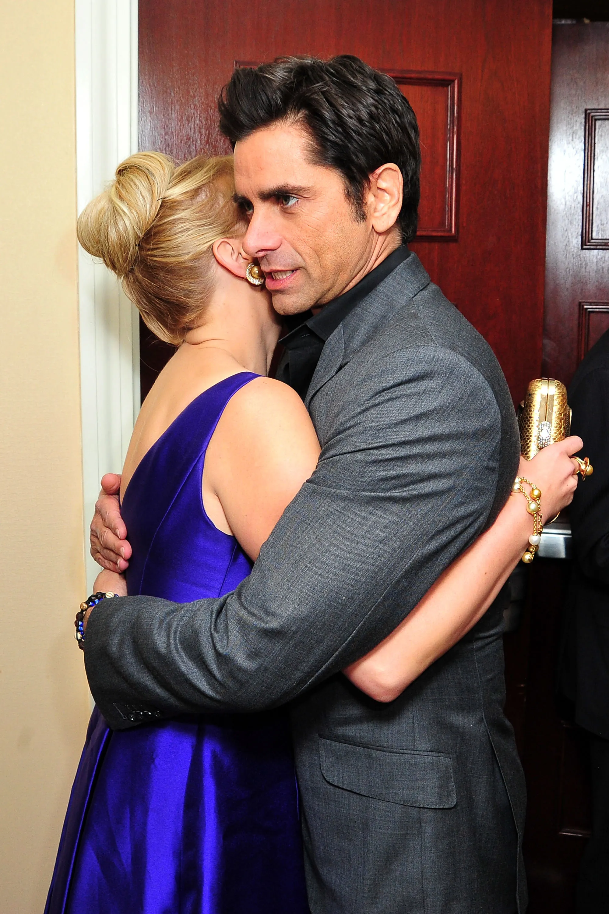 Jodie Sweetin and John Stamos hugging.