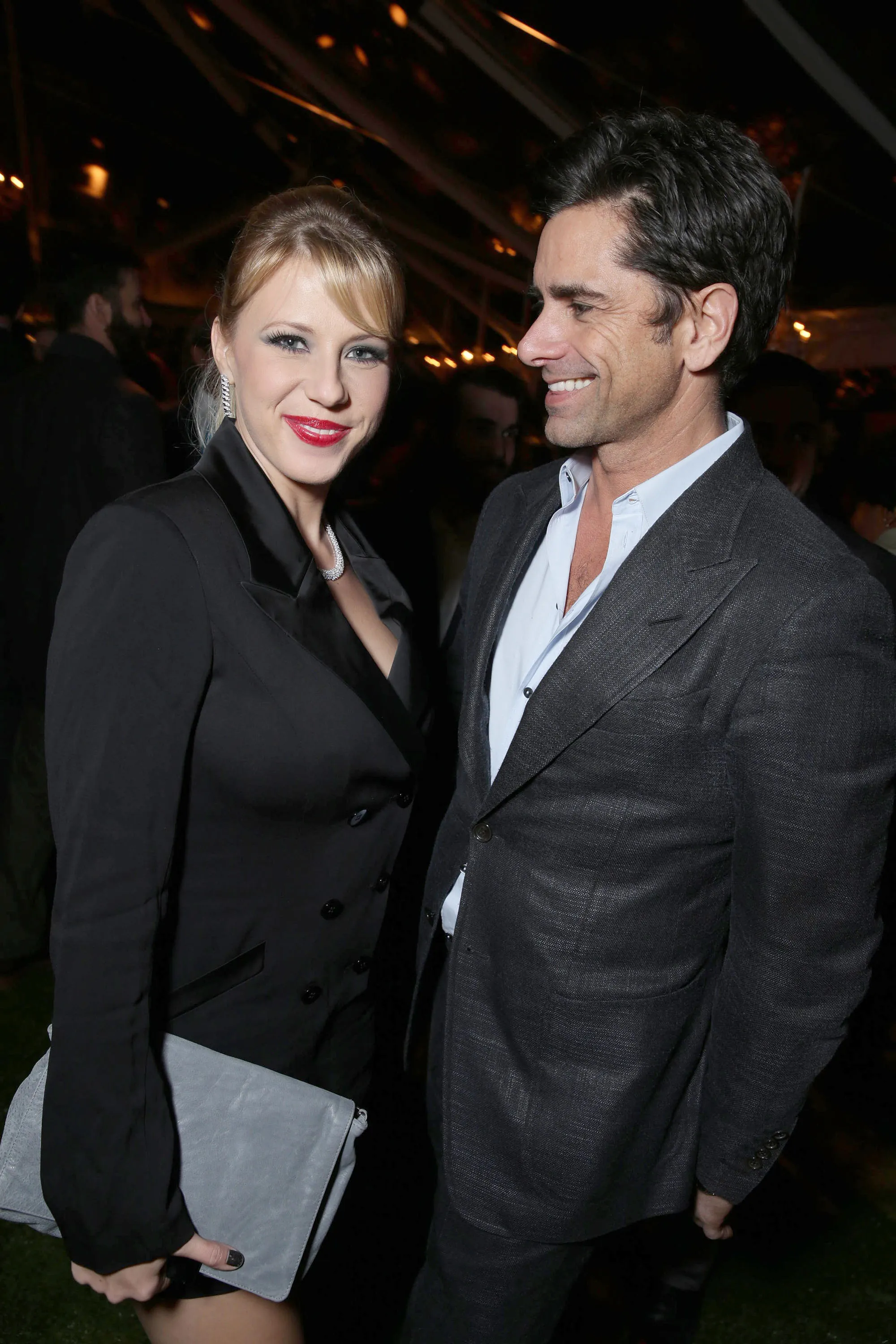 Jodie Sweetin and John Stamos posing for a picture at an event.