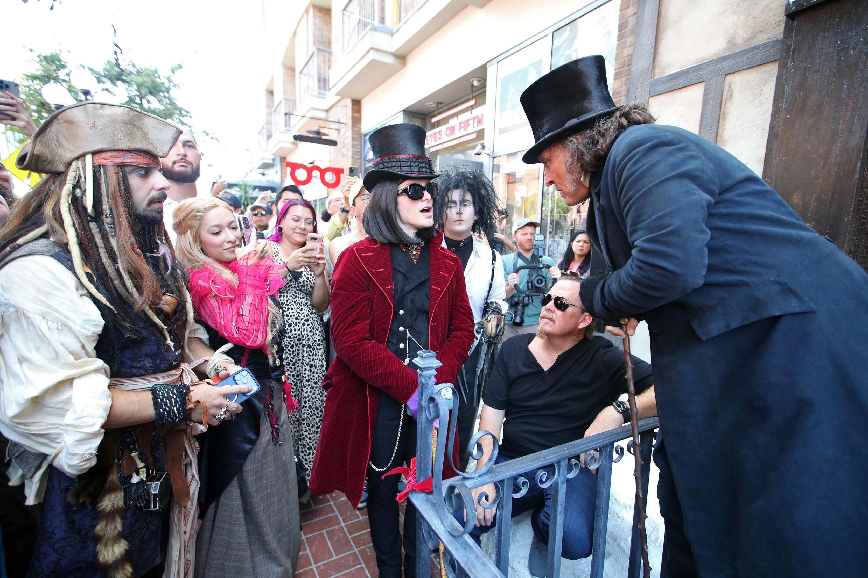 Johnny Depp interacting with cosplayers dressed as Captain Jack Sparrow, Willy Wonka, and Edward Scissorhands at the Paramount Pictures San Diego Comic-Con Ebenezer Office Activation.