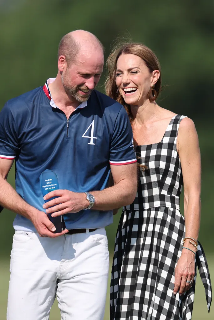 Prince William, in a black top and white pants, and Kate Middleton, in a black and white checked dress, laugh together at a charity polo match.