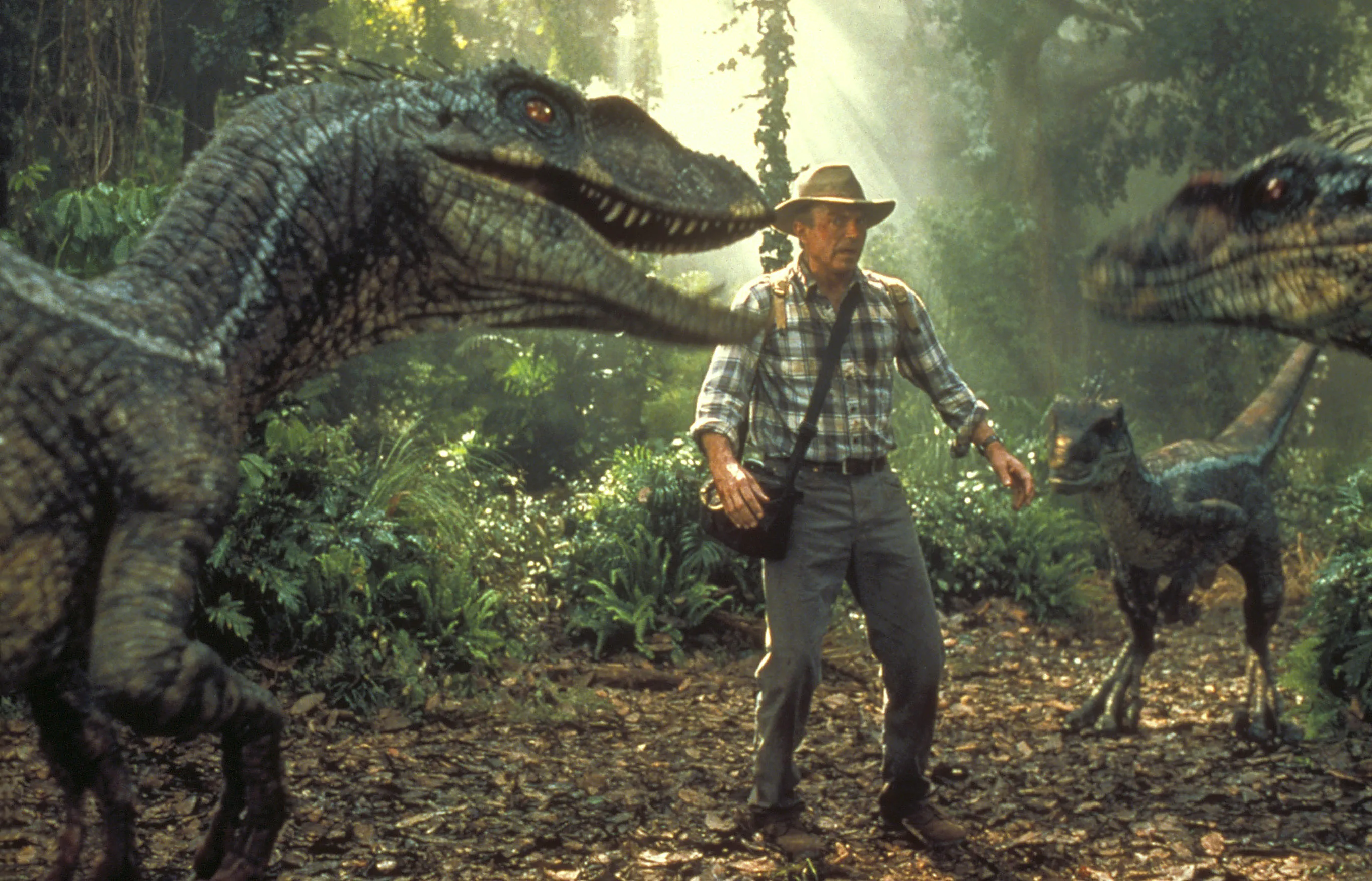 Sam Neill surrounded by dinosaurs in Jurassic Park III.