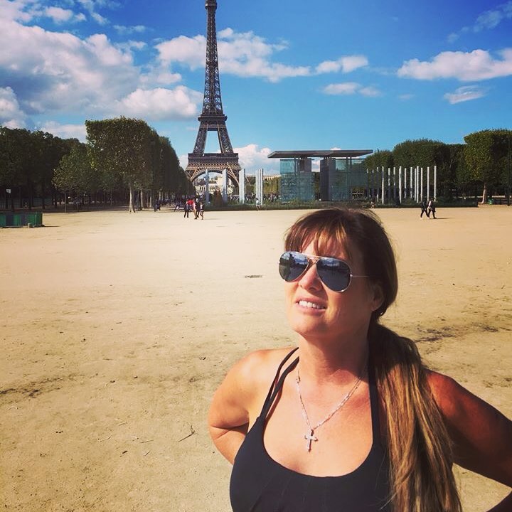 Kara Keough poses in front of the Eiffel Tower.
