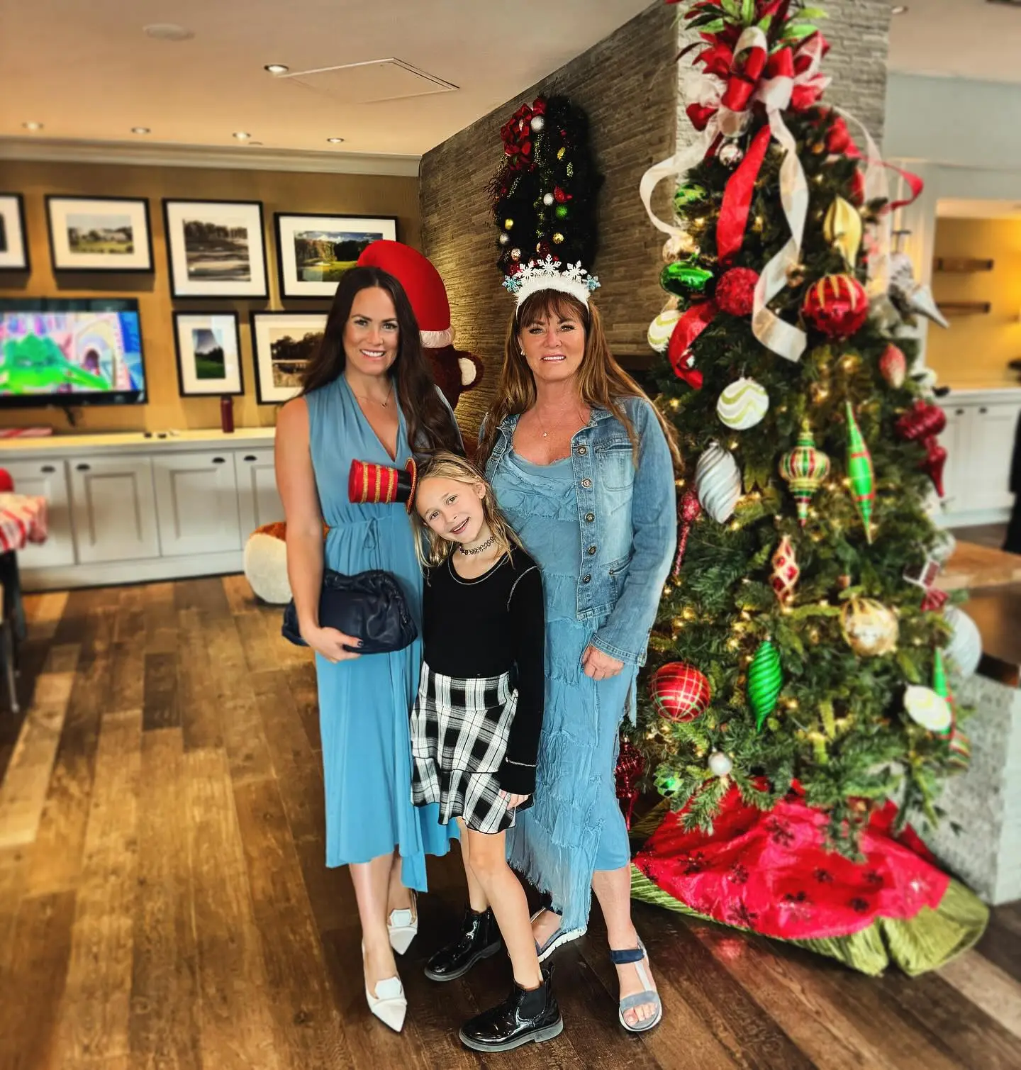 Kara Keough with her mother and daughter in front of a Christmas tree.