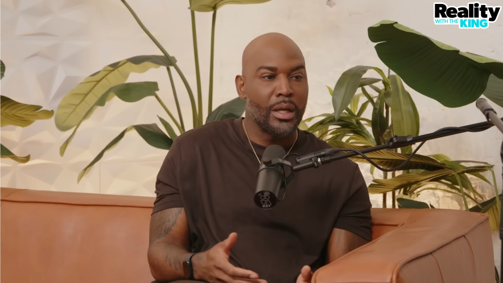 Karamo Brown speaking into a microphone.