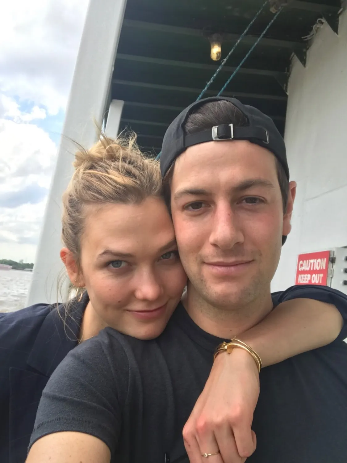 Karlie Kloss and Jared Kushner posing together on a boat.