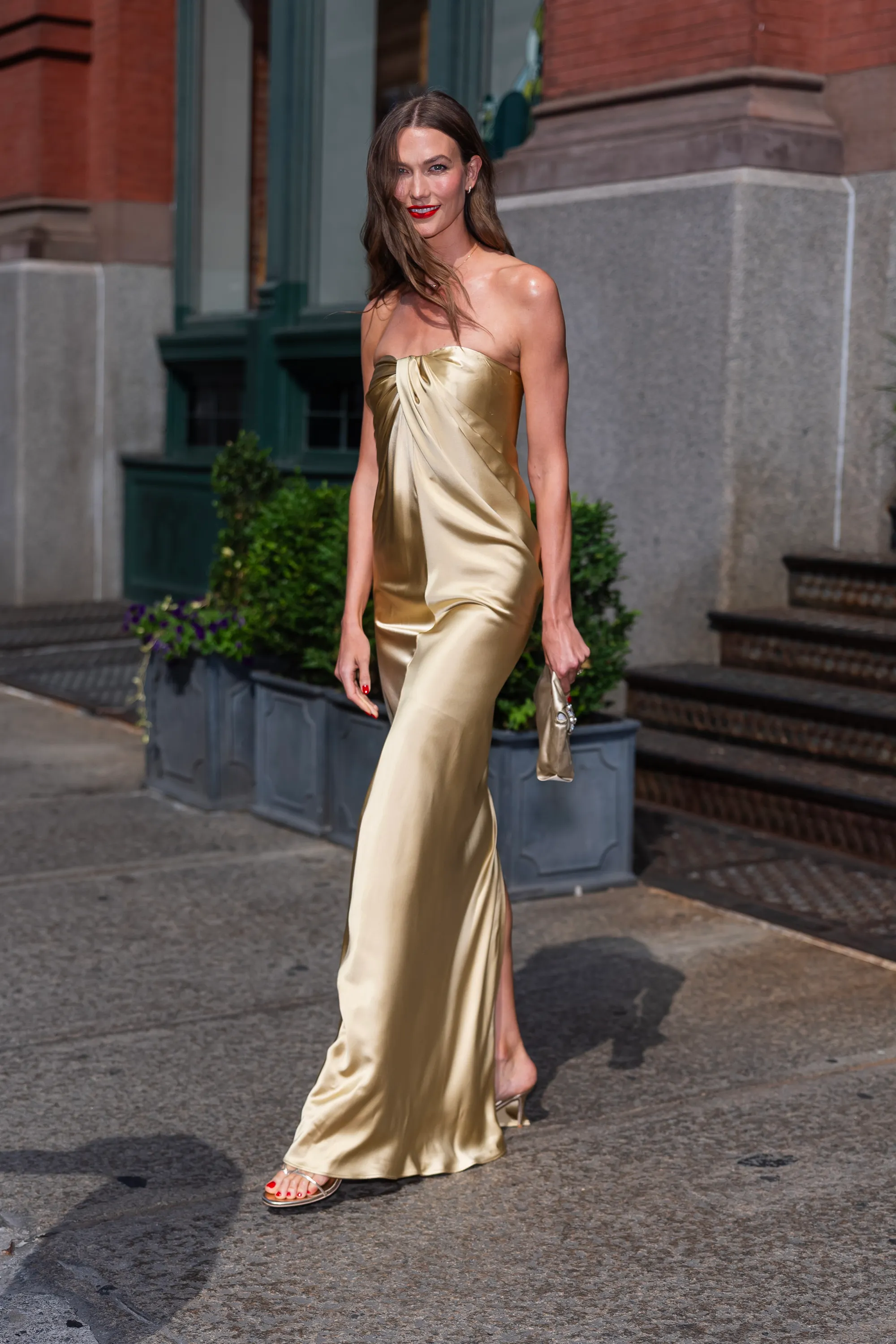 Karlie Kloss in a gold strapless gown.
