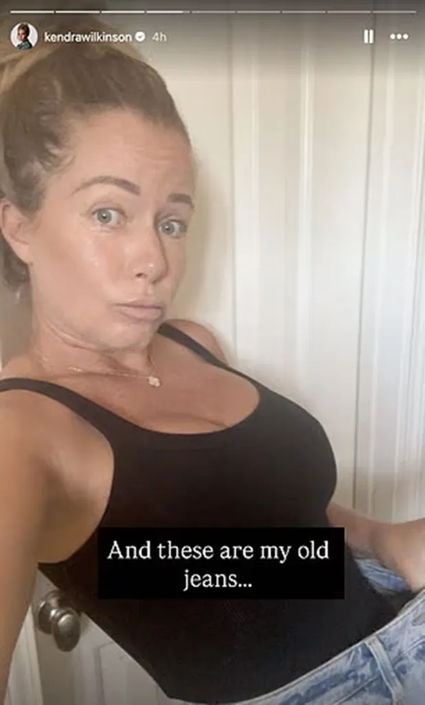 Kendra Wilkinson in a black tank top and old jeans.