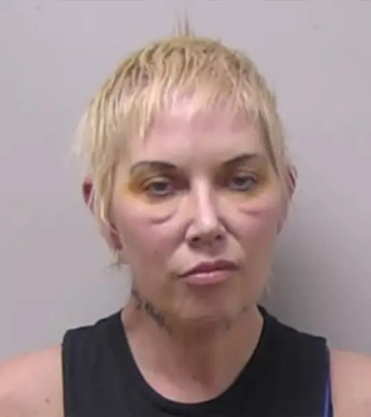 Mugshot of Kim Scott with noticeable bruising around her eyes.