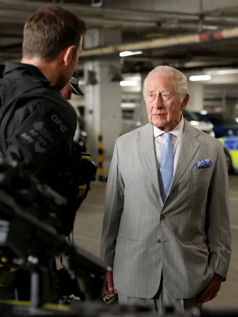 King Charles III speaking with firearms officers at the British Transport Police headquarters.
