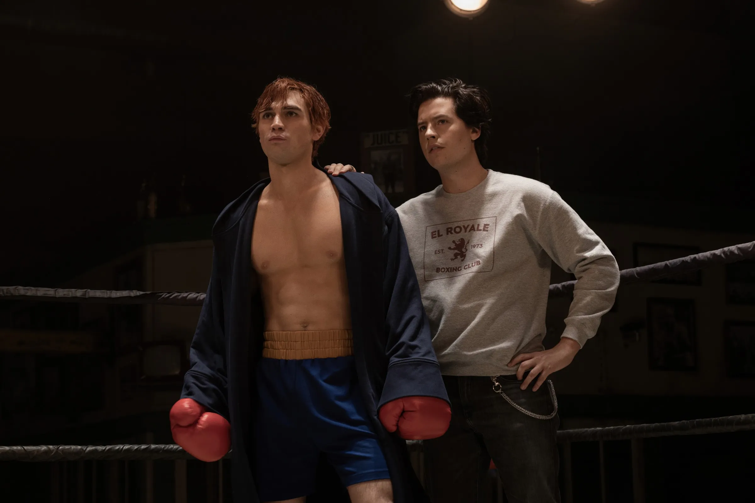 KJ Apa and Cole Sprouse in a boxing ring.