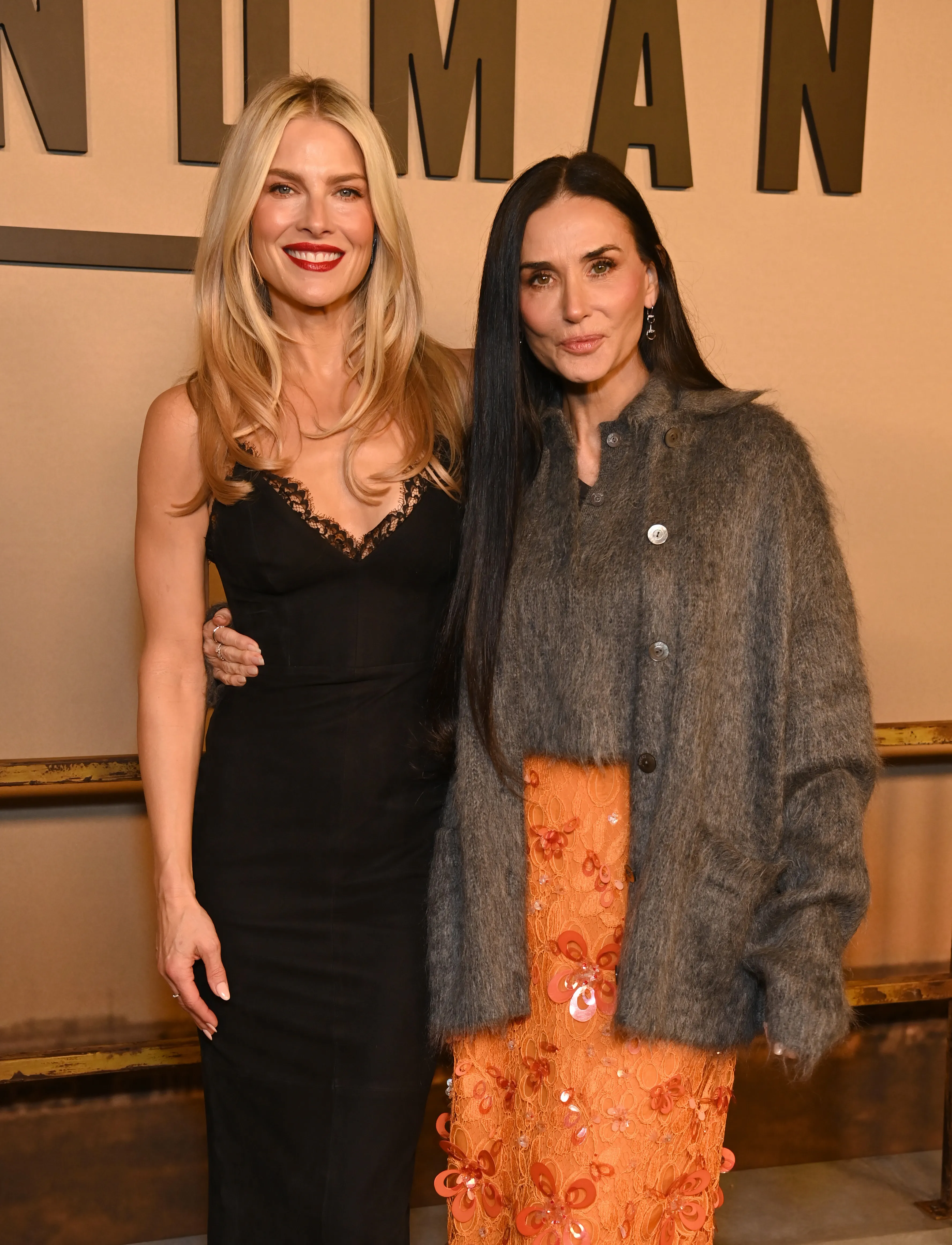 Ali Larter and Demi Moore posing together at an event.