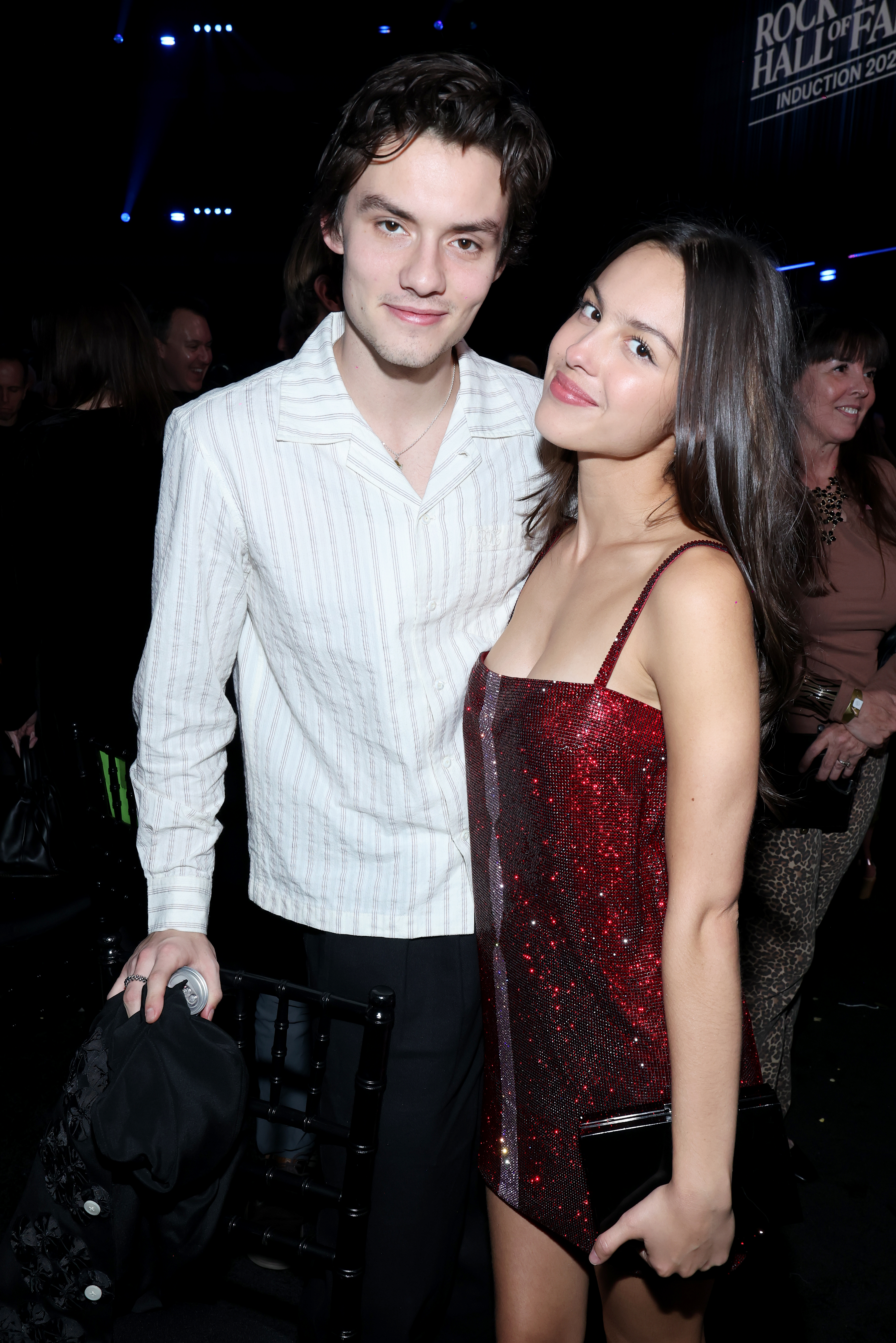 Louis Partridge and Olivia Rodrigo pose for a photo at the 2025 Rock & Roll Hall of Fame Induction Ceremony.