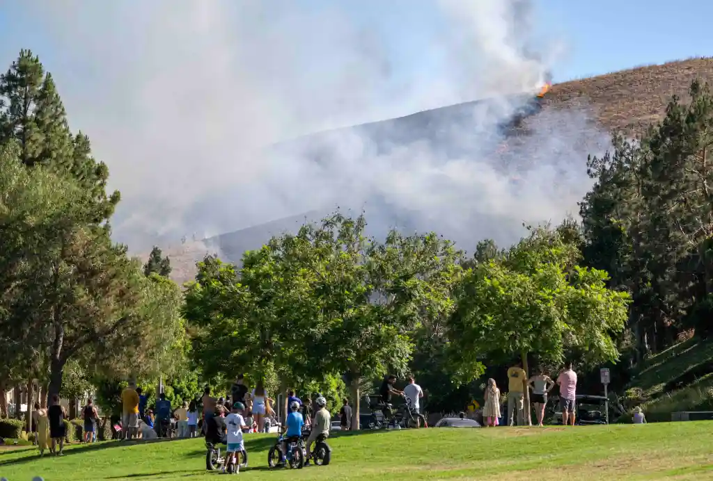 Residents observe flames engulfing a hillside in Ladera Ranch.