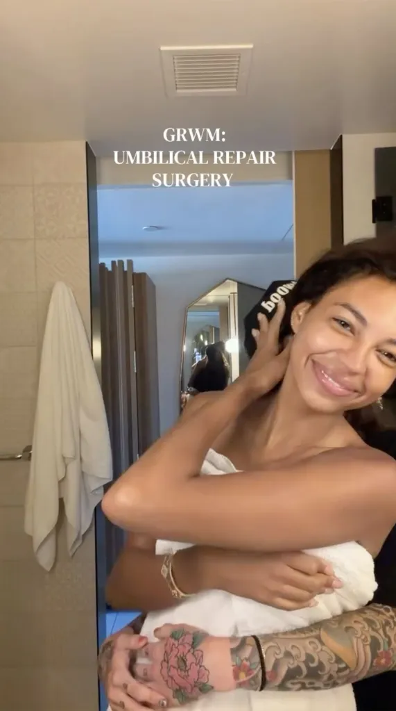 Layla Taylor and Kelsie Chesser smiling while Layla is wrapped in a towel with Kelsie's tattooed arms around her.