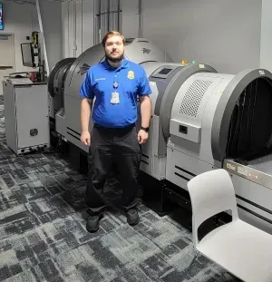 Lead TSA Officer Justin Dupree in the checked baggage screening area.