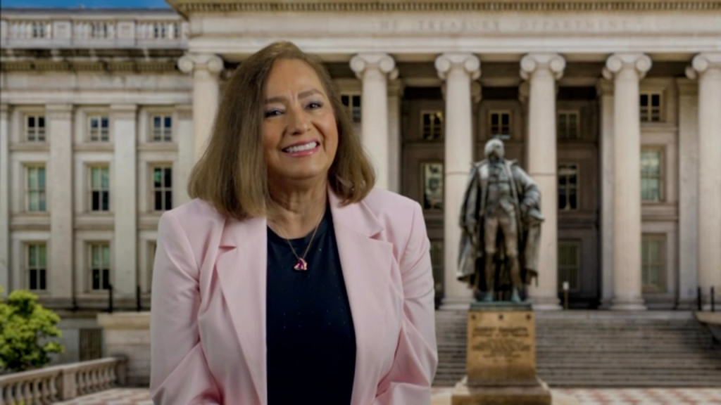 Rosario Marin smiling in front of the US Treasury Department.