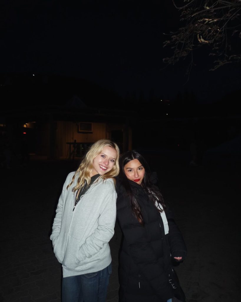 Lexi Minetree, Chandler Kinney, and Danielle pose together at night.