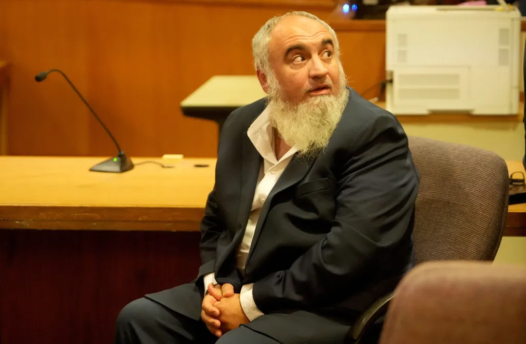 Loay Alnaji waits in a courtroom after being sentenced to one year in jail.