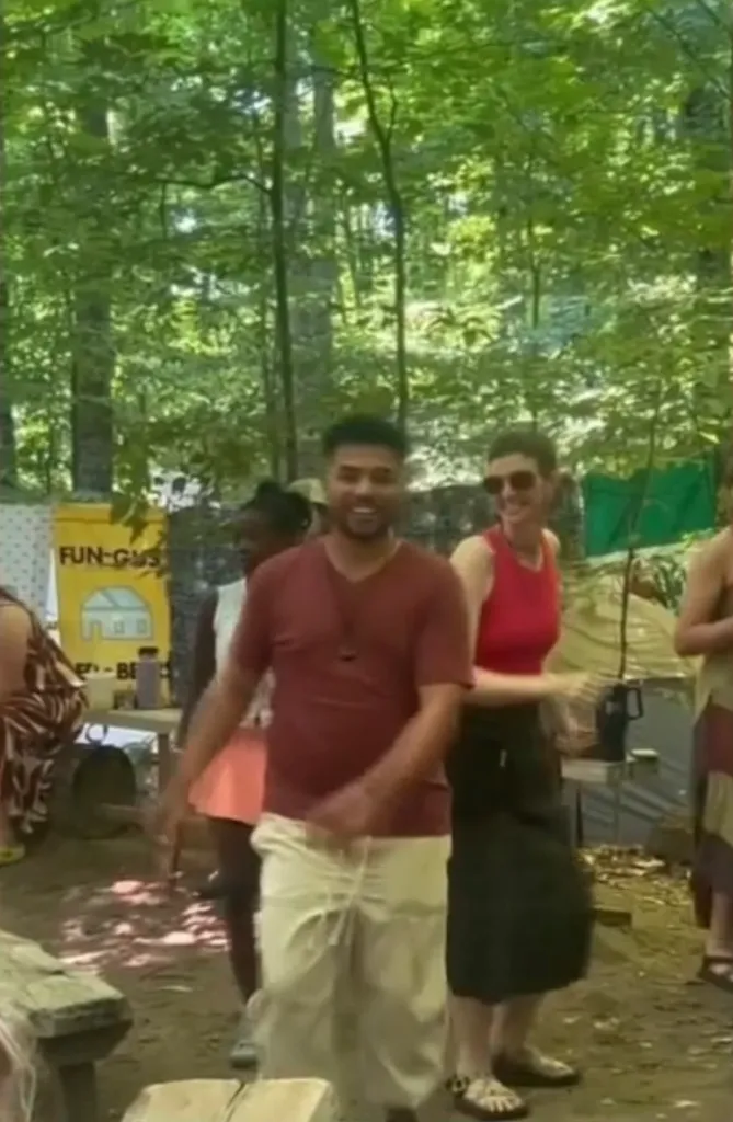 A group of people dancing outdoors at a Michigan music festival.