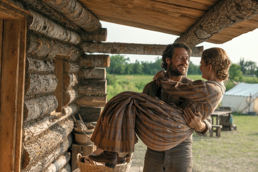 Luke Bracey carrying Crosby Fitzgerald in his arms.