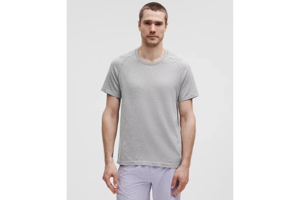 A man wearing a grey ventilated shirt.