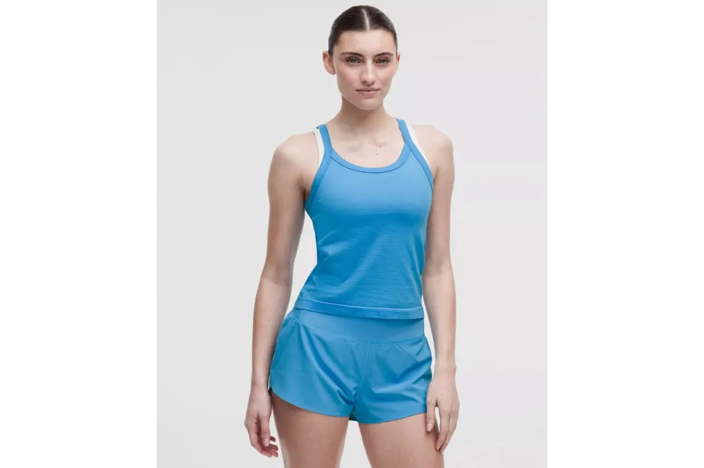 A woman in a blue tank and matching shorts.