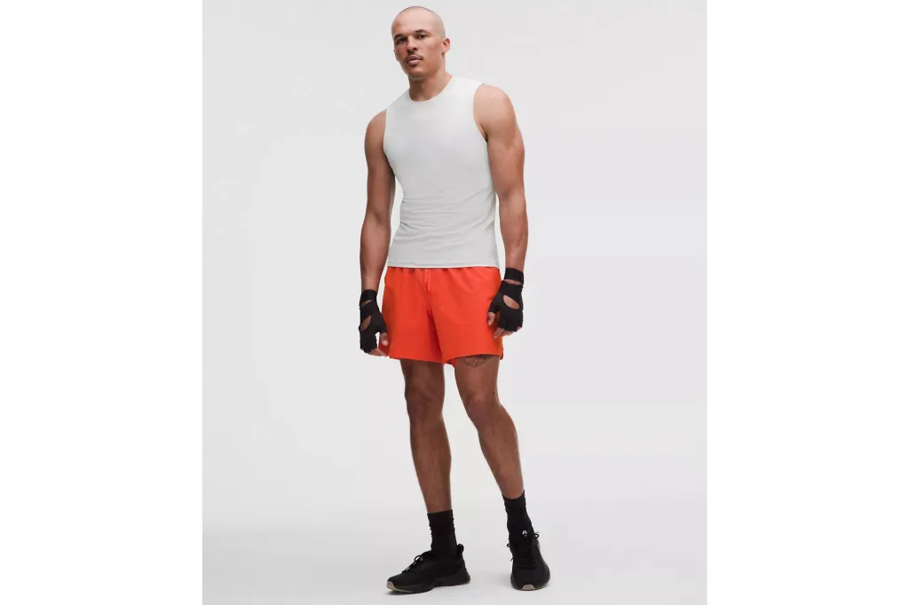 A man in a pair of shorts and a tank.
