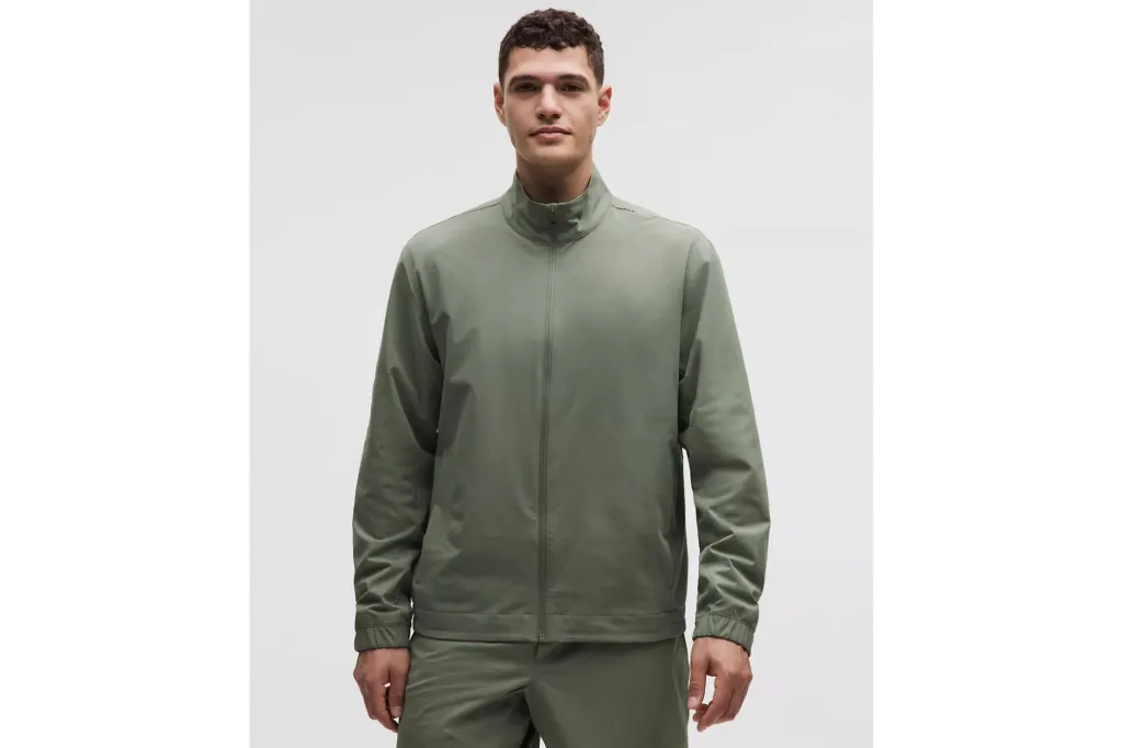 A man in a lightweight jacket in the color olive.