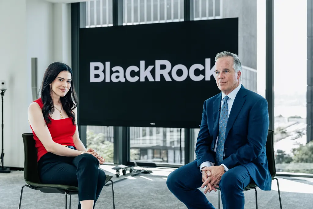 Lydia Moynihan and John Kelly sitting in front of a BlackRock screen.