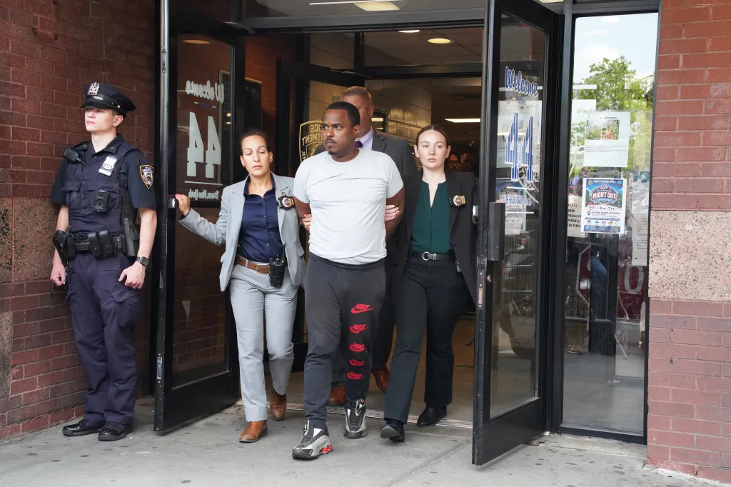 William Ferrer being escorted by detectives out of the 44th Precinct in the Bronx, New York.