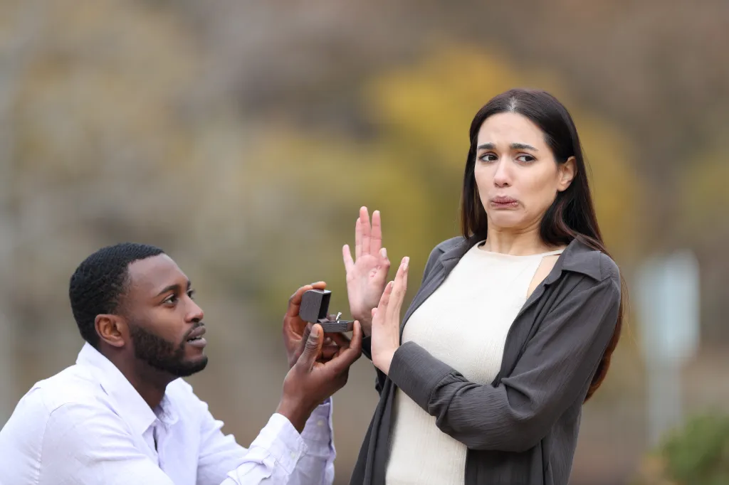 A man proposing marriage to a woman who is rejecting him.