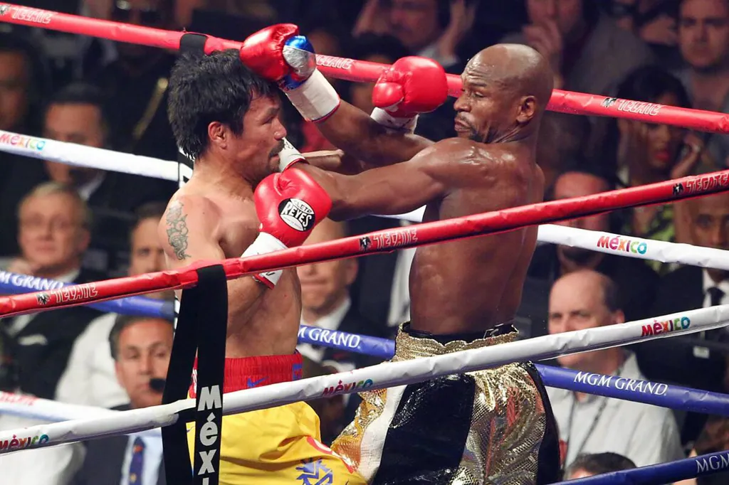 Manny Pacquiao and Floyd Mayweather Jr. boxing in a ring.