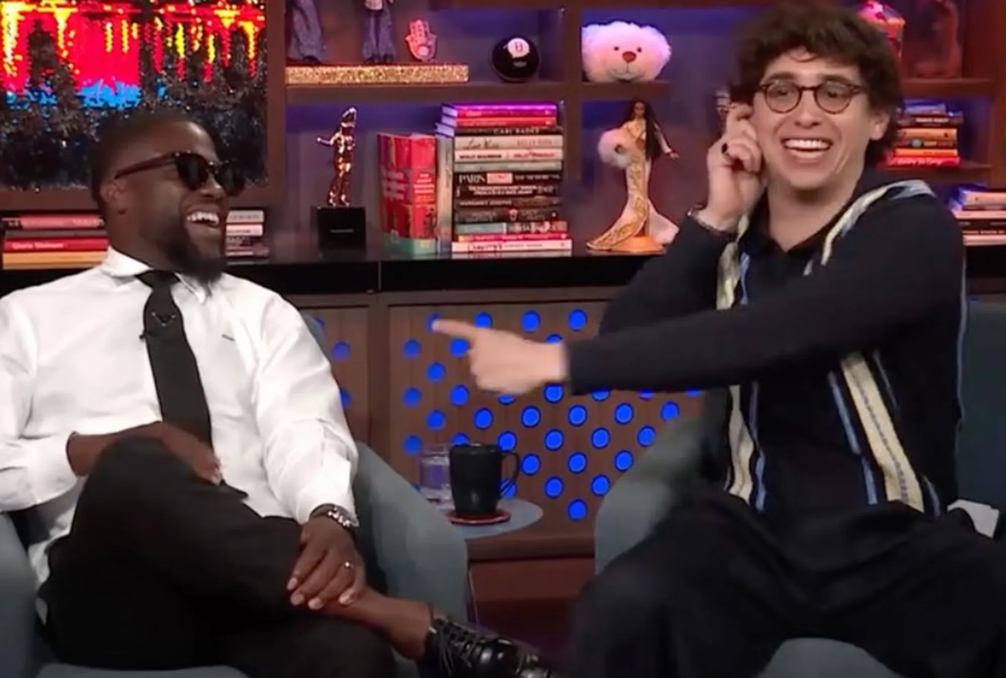 Kevin Hart and Marcello Hernandez laughing during a TV show appearance.