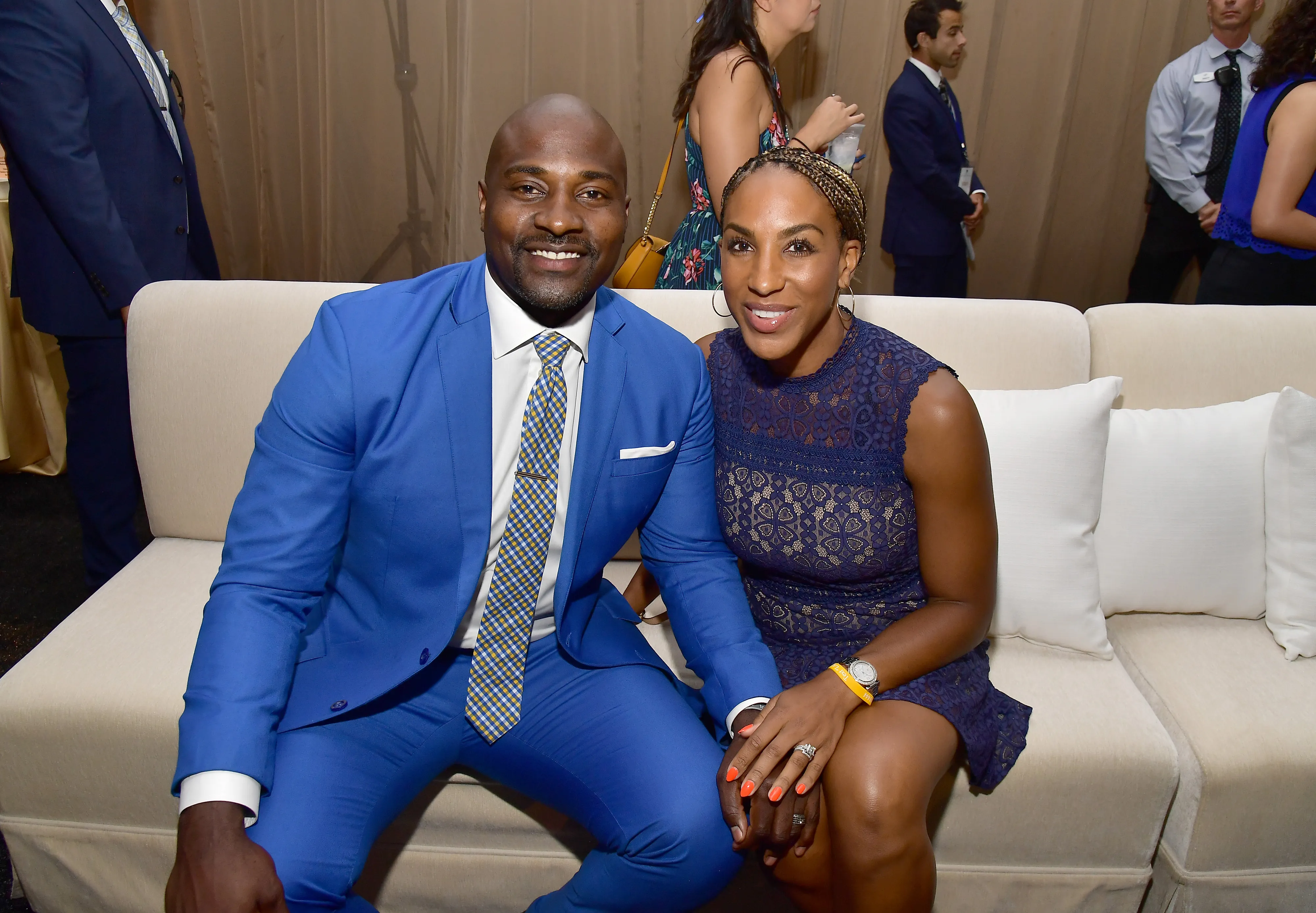 Marcellus Wiley and Annemarie Wiley smiling while seated on a sofa.