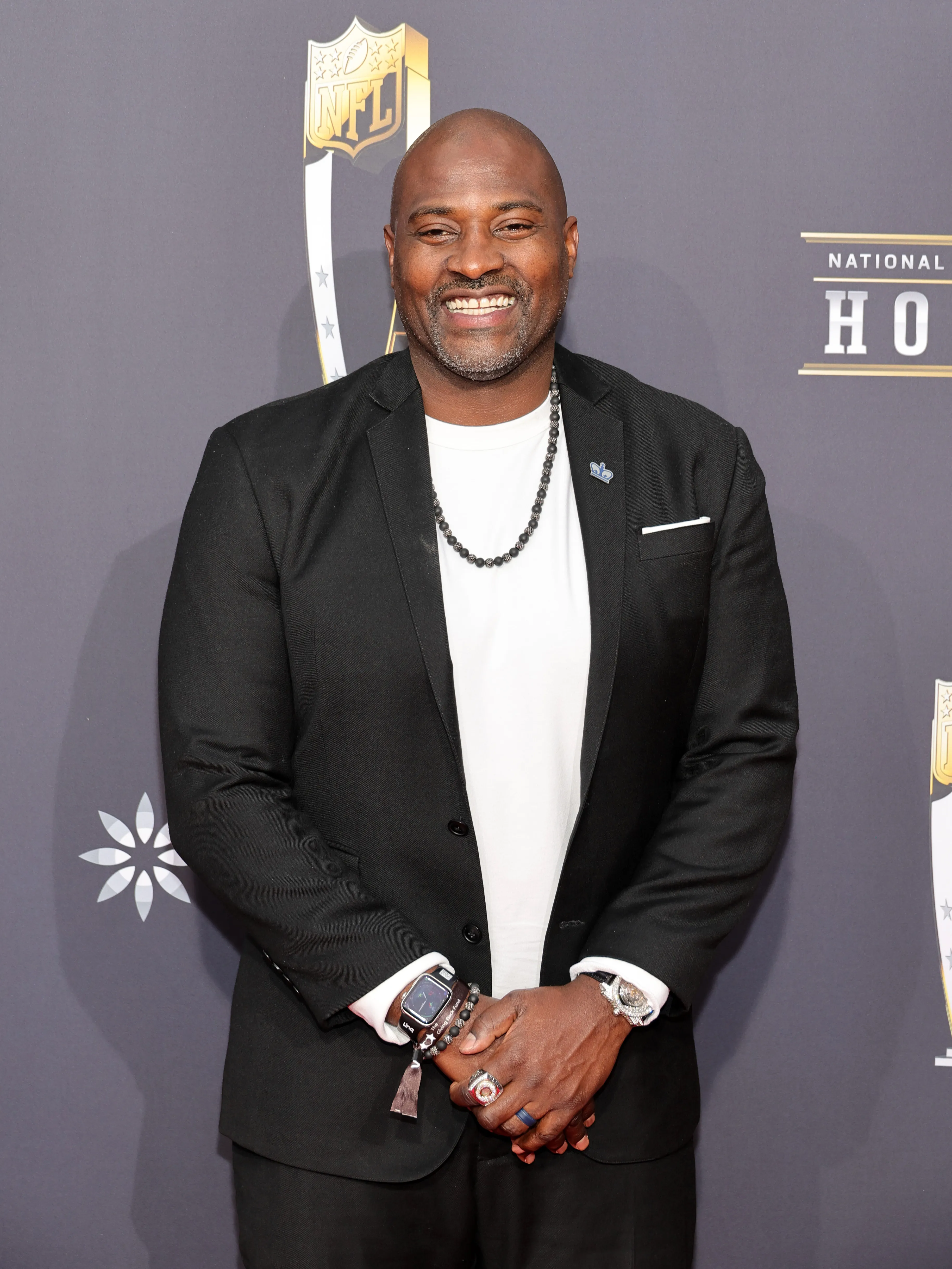 Marcellus Wiley smiling and posing at the 13th Annual NFL Honors event.