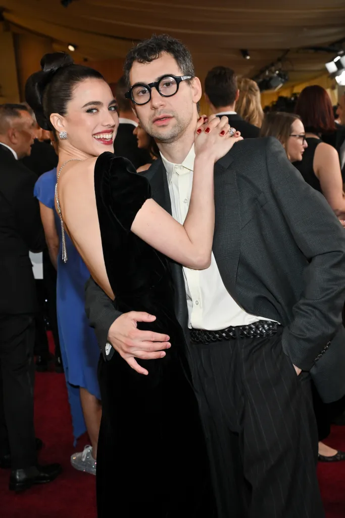 Margaret Qualley in a black velvet dress and Jack Antonoff in a gray suit at the 97th Oscars.