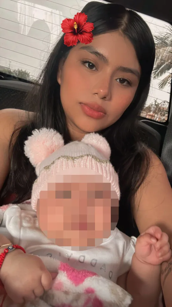 Maria Barrios Ventura holding her infant daughter, whose face is pixelated.
