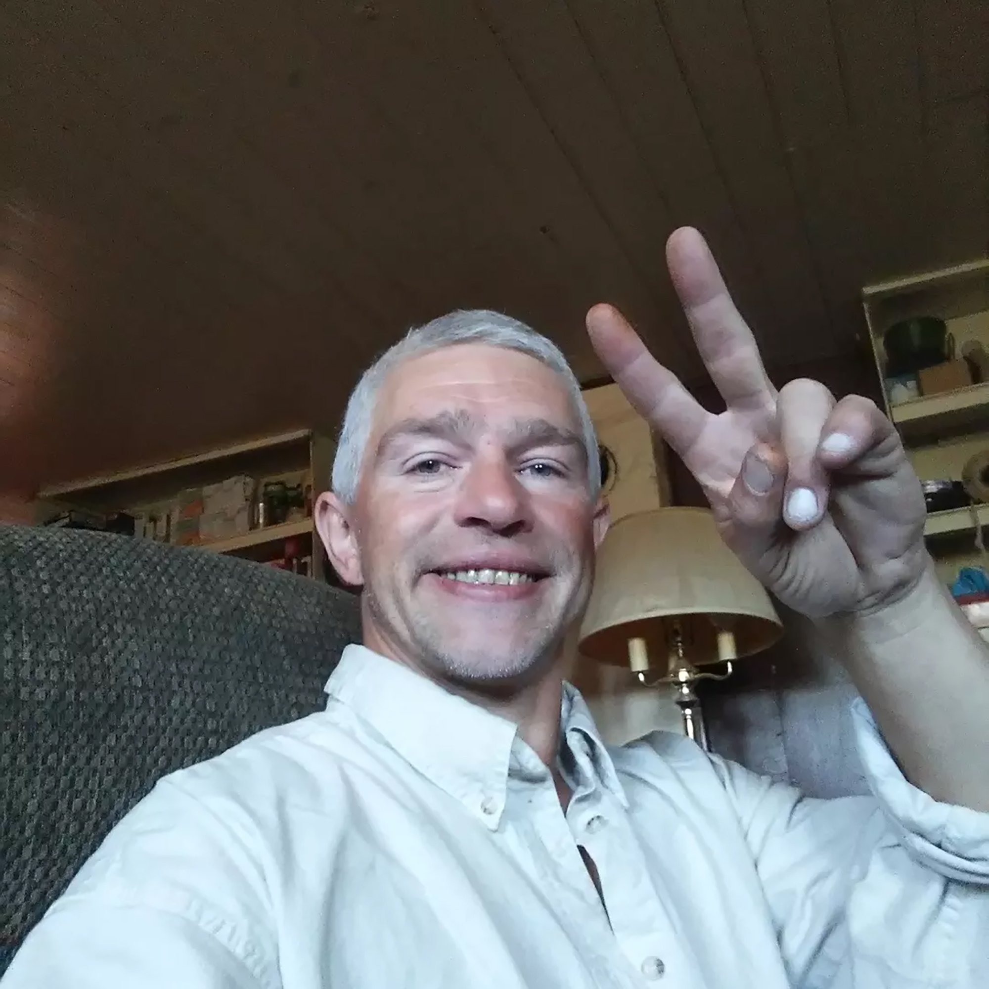 Matt Brown taking a selfie, flashing a peace sign.