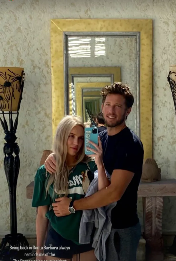 Matt Kaplan, in a black T-shirt, and Alex Cooper, in a green T-shirt, taking a mirror selfie.