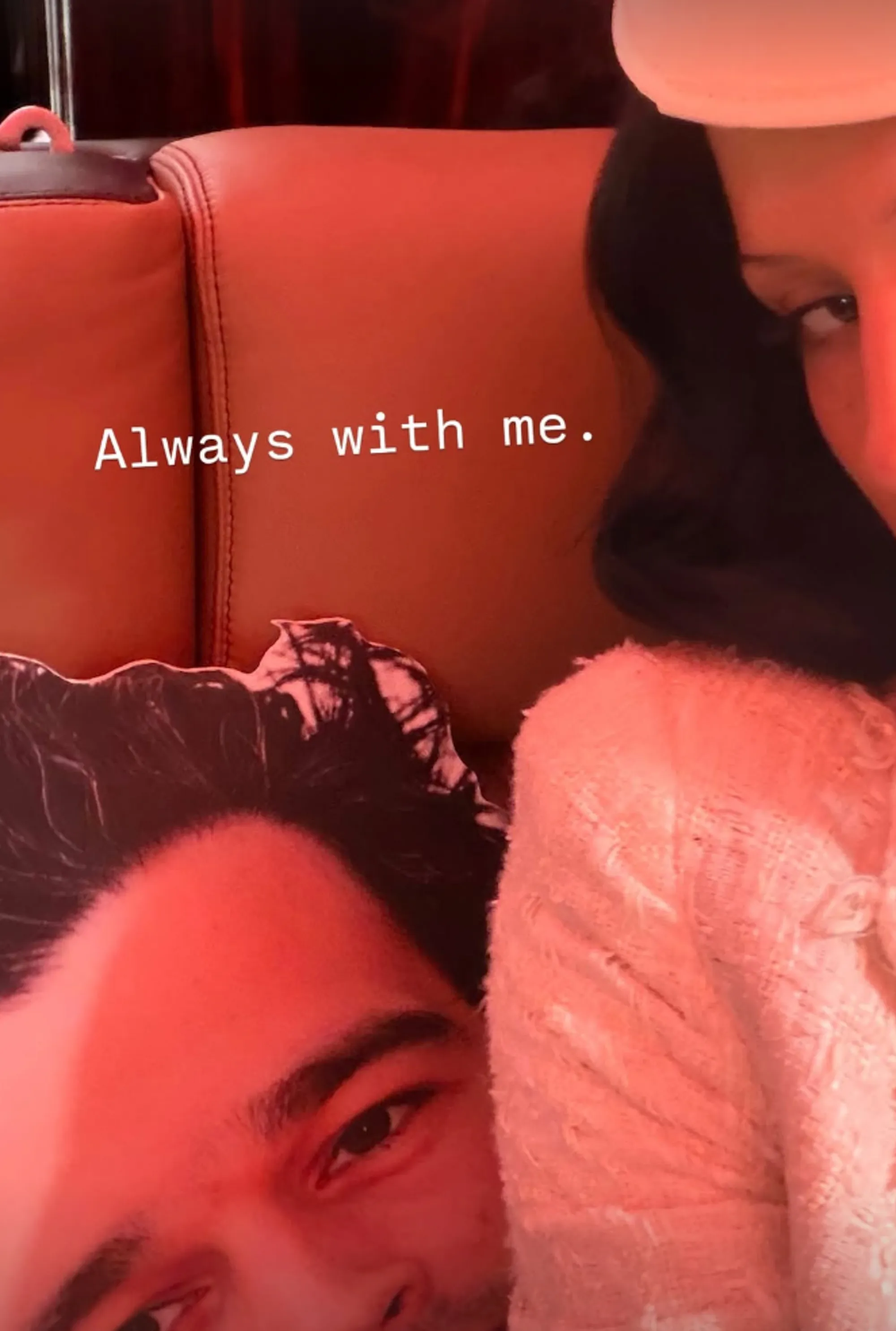 A woman in a white coat sits with a cardboard cutout of a man's face, captioned 