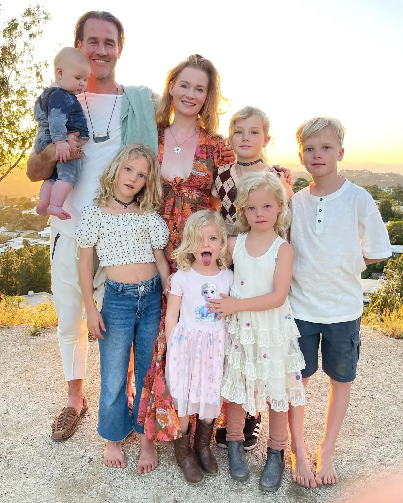 James Van Der Beek, his wife Kimberly, and their six children pose for a family photo at sunset.