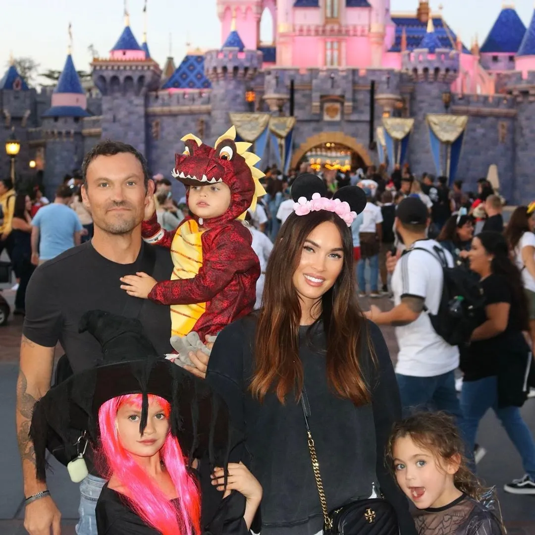 Megan Fox and Brian Austin Green with their sons dressed in costumes at Disneyland.
