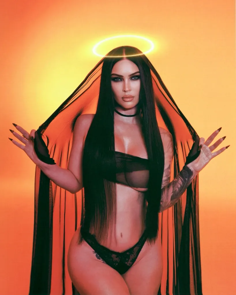 Megan Fox in black lingerie with a sheer veil and a halo effect.