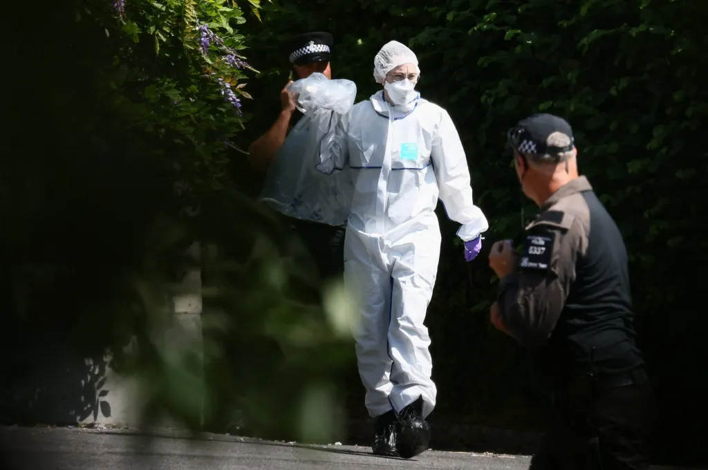 Forensic team members walk around the crime scene of Widdecombe's murder at her home in Haytor, Britain, on July 11, 2026.
