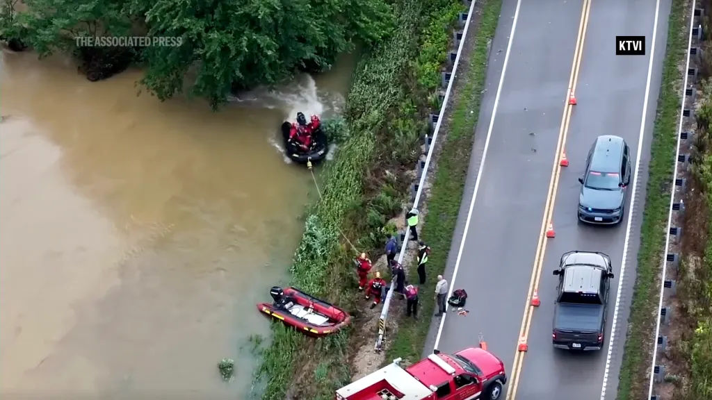 Emergency crews rescuing people from a flooded river in Missouri.
