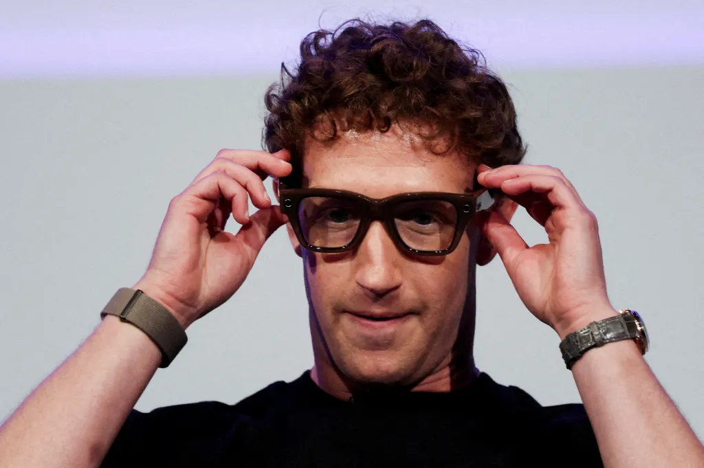 Meta CEO Mark Zuckerberg putting on Meta Ray-Ban Display glasses.